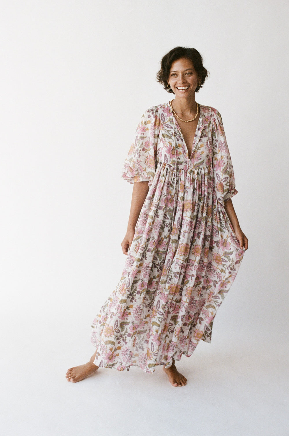 Daughters of India Kyra Maxi Dress in Fuchsia Bloom — studio full length smiling, V-neckline, flowing botanical print
