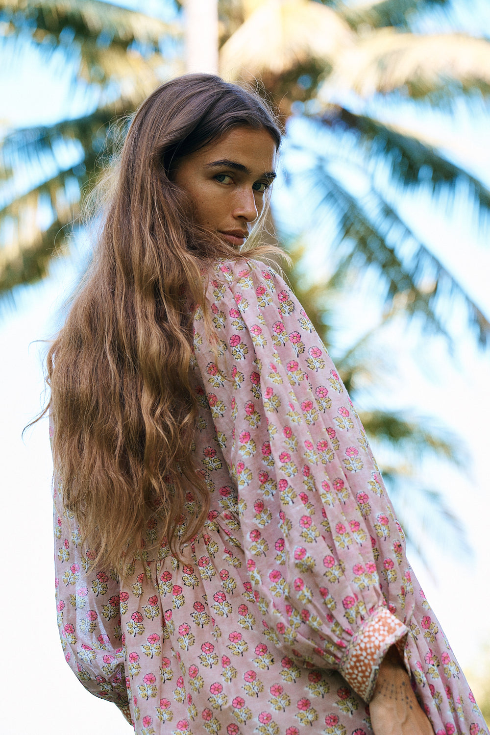 Bhoomi Maxi Dress Sunset — over-shoulder look under palm tree, hand block print ethical cotton | Daughters of India