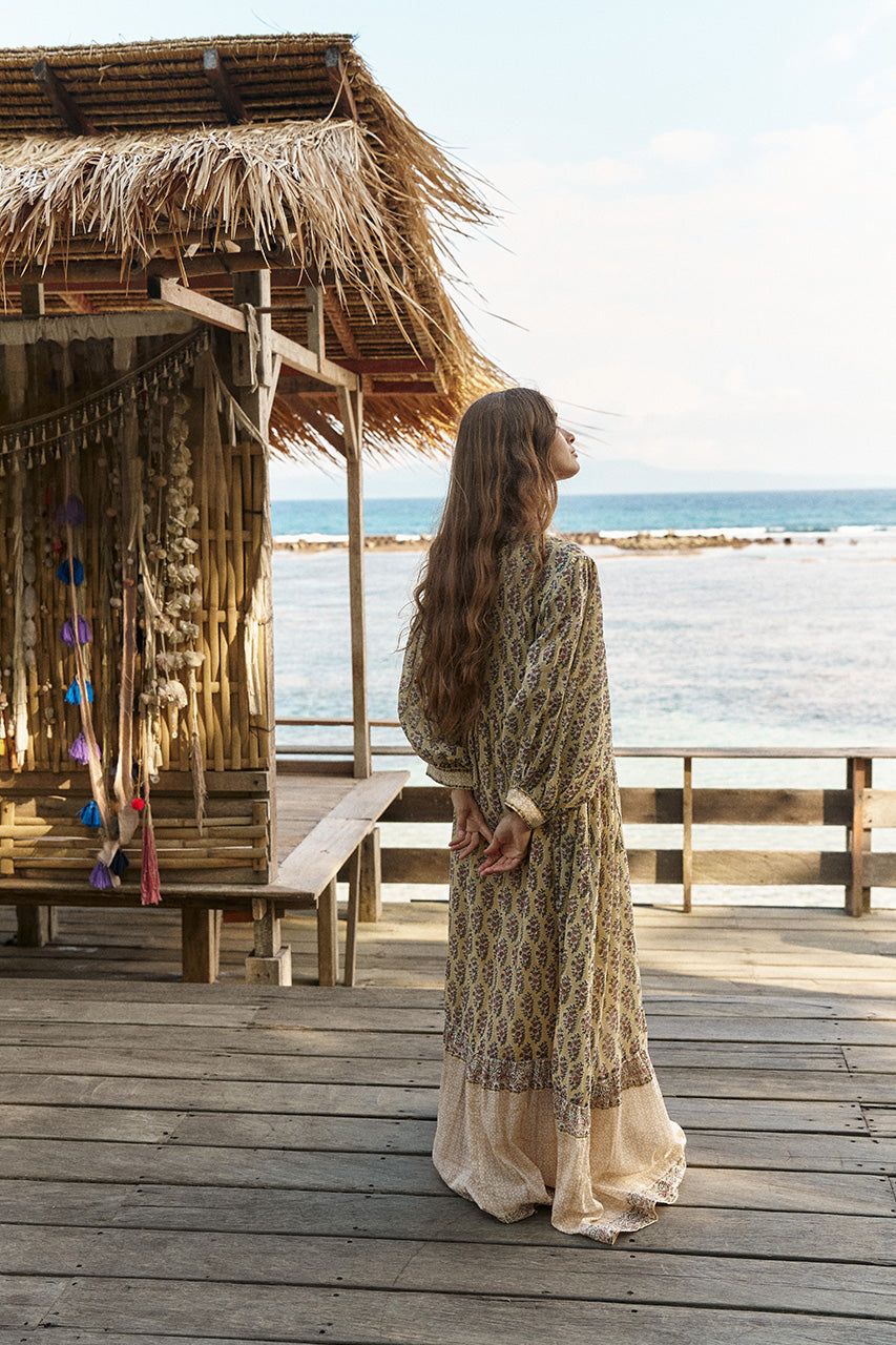 Bhoomi Maxi Dress Meadow — back profile on ocean deck at tropical beach hut, hand block print cotton | Daughters of India